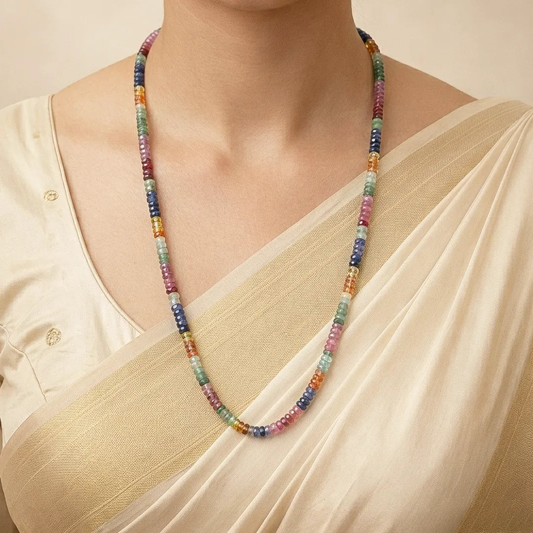 Multicolored beaded necklace worn by a person in a beige outfit