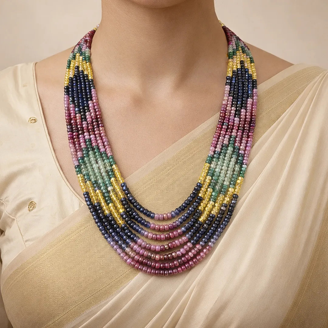 Multicolored beaded necklace worn by a person in a beige outfit.
