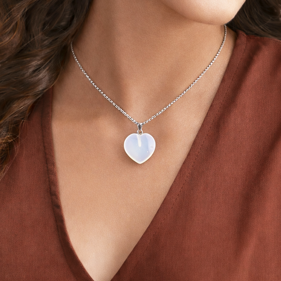 Heart-shaped pendant necklace on a person wearing a brown topOpalite Heart Pendant (Abhimantrit) for Calmness & Emotional Balance