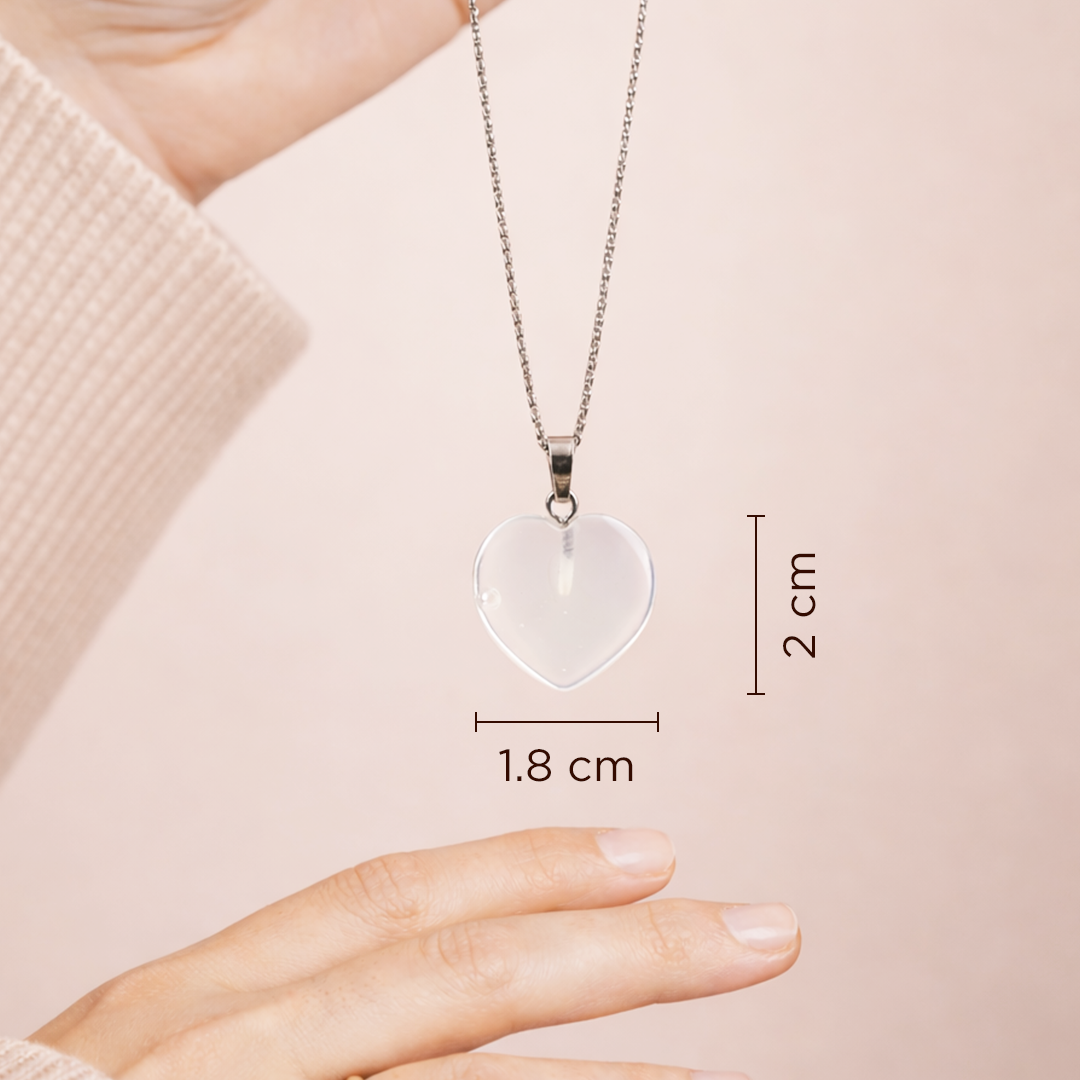 Heart-shaped pendant necklace on a chain, held by a hand with measurements displayed.Opalite Heart Pendant (Abhimantrit) for Calmness & Emotional Balance