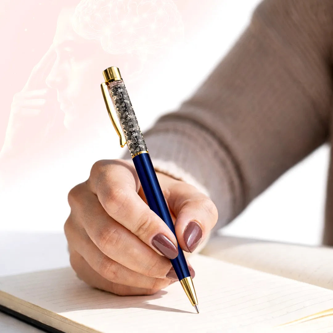 Hand holding a blue pen with gold accents on a light background