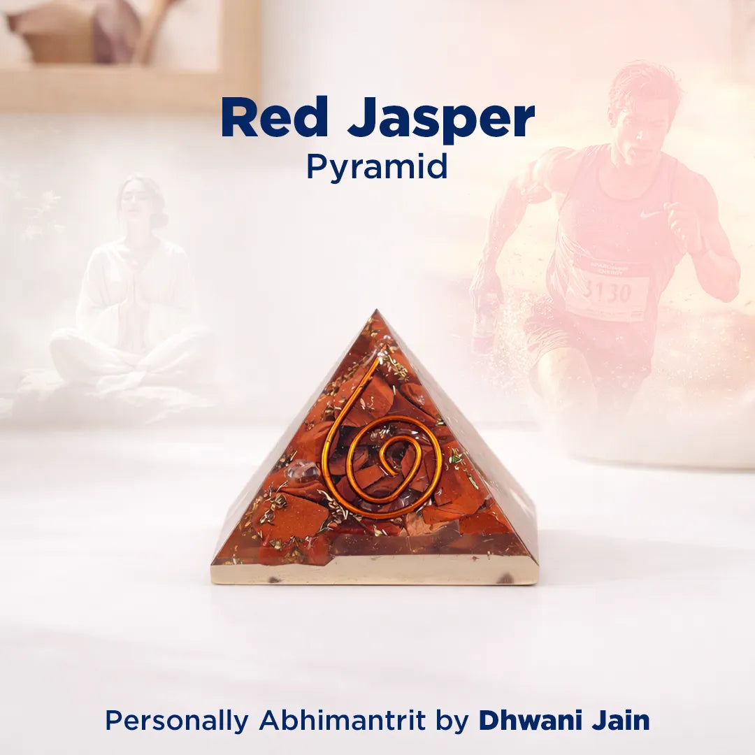 Red Jasper pyramid with a symbol on a white surface, branded 'Red Jasper Pyramid' by Dhwani Jain.