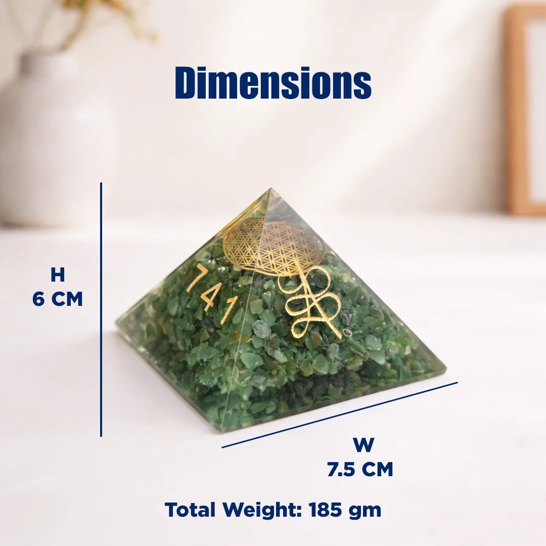 Green pyramid crystal with gold emblem and measurements on a white background