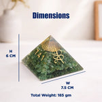 Green pyramid crystal with gold emblem and measurements on a white background