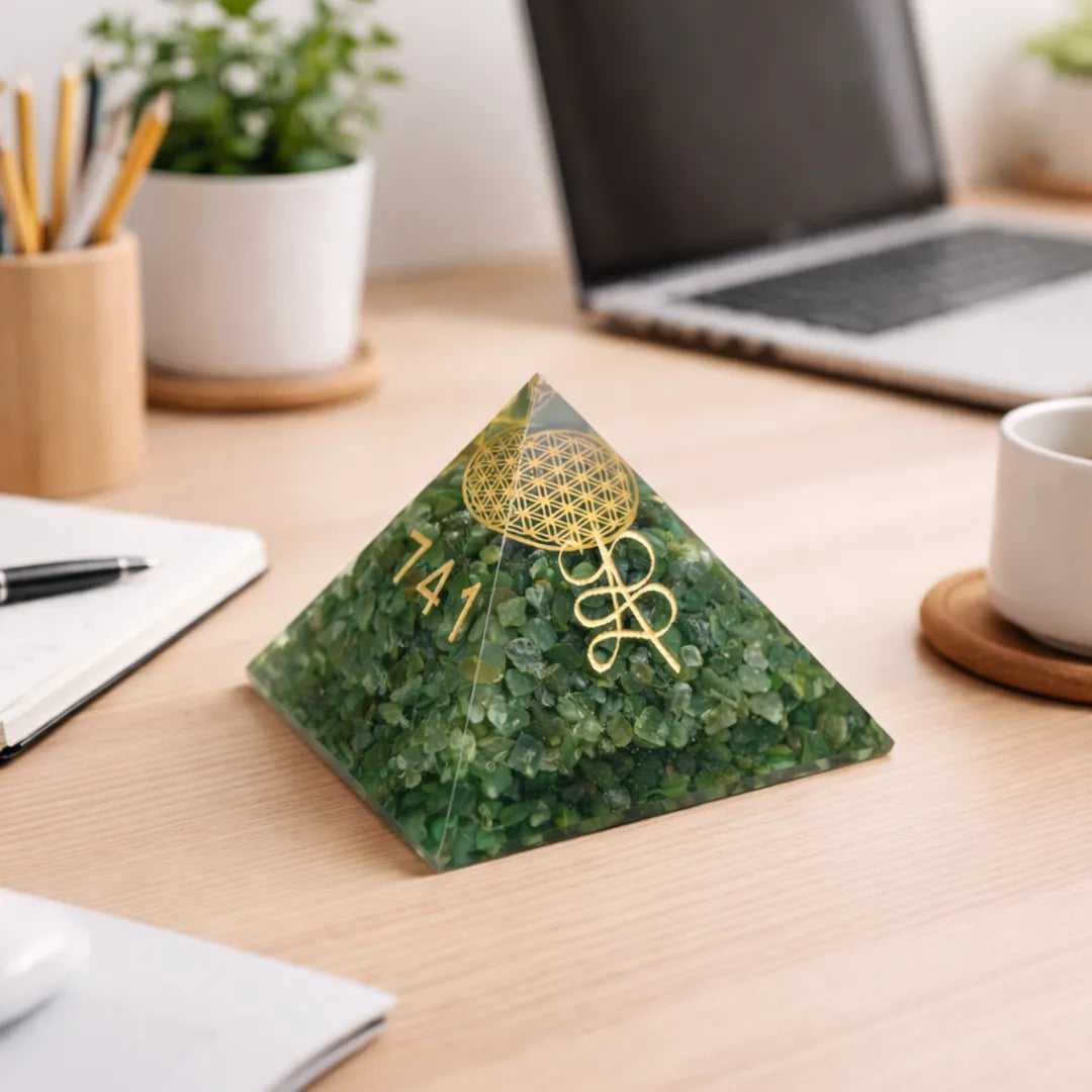 Green pyramid decorative item on a desk with laptop and office suppliesReiki Symbol Zibu Pyramid – Energy Healing & Manifestation Crystal