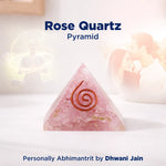 Rose Quartz pyramid with a spiral design on a soft white background