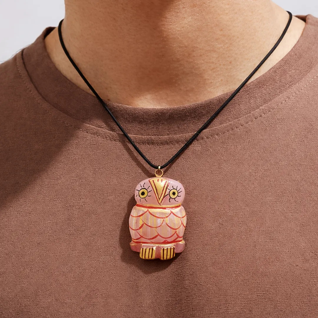 Person wearing a necklace with an owl pendant on a plain backgroundRose Quartz Owl Pendant – Love & good luck Crystal Pendant