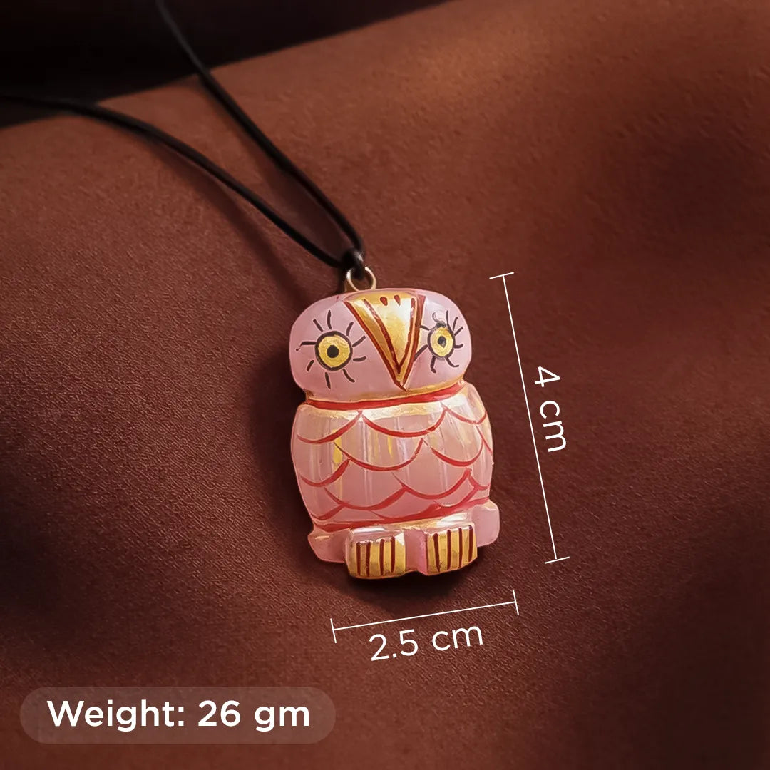 Pink owl-shaped pendant with measurements and weight on a brown backgroundRose Quartz Owl Pendant – Love & good luck Crystal Pendant