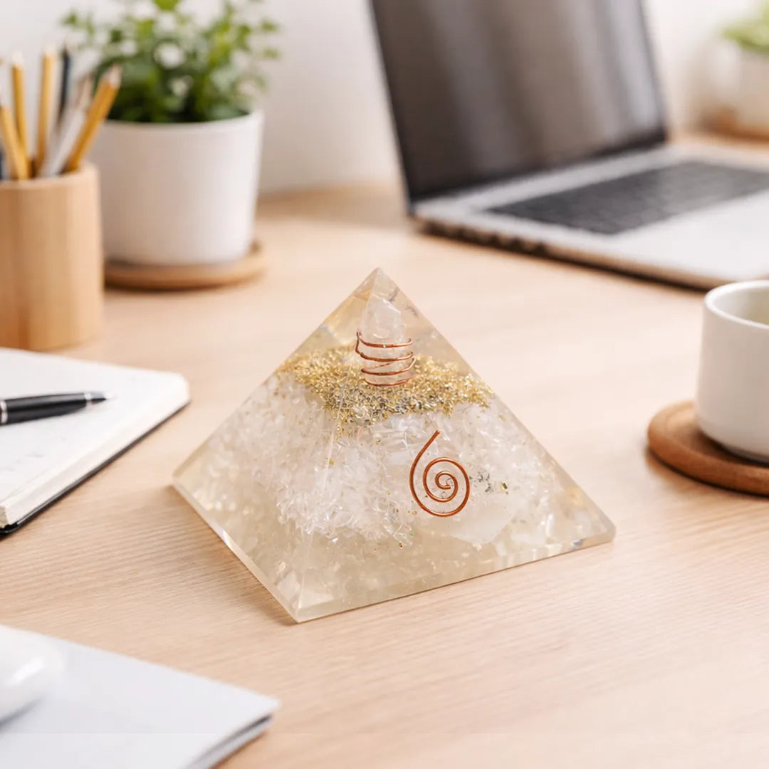 Crystal pyramid on a desk with laptop, notebook, and cup in the backgroundSelenite Pyramid with Shree Yantra – Energy Cleansing & Spiritual Clarity