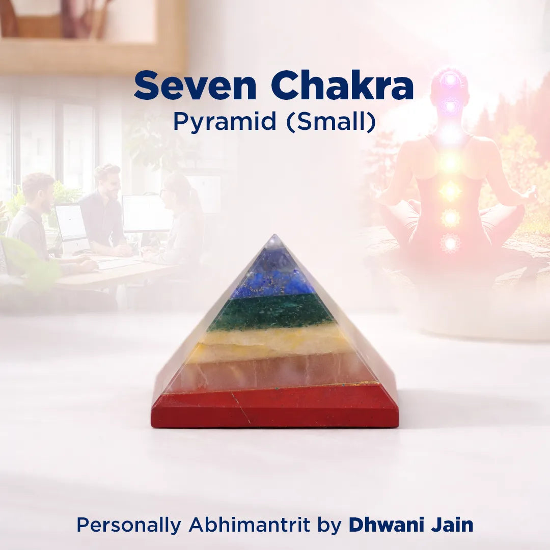 Seven Chakra Pyramid on a white surface with blurred background