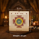 Decorative panel with a symbol and measurements on a wooden stand with a blurred background.