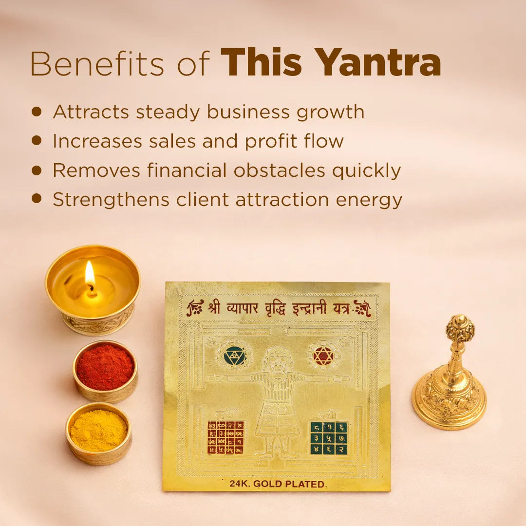 Gold-plated yantra with candles, powders, and a lamp on a beige background