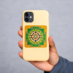 Phone case with a geometric design held by a hand against a gray background