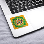 Decorative coaster with a geometric design on a laptop