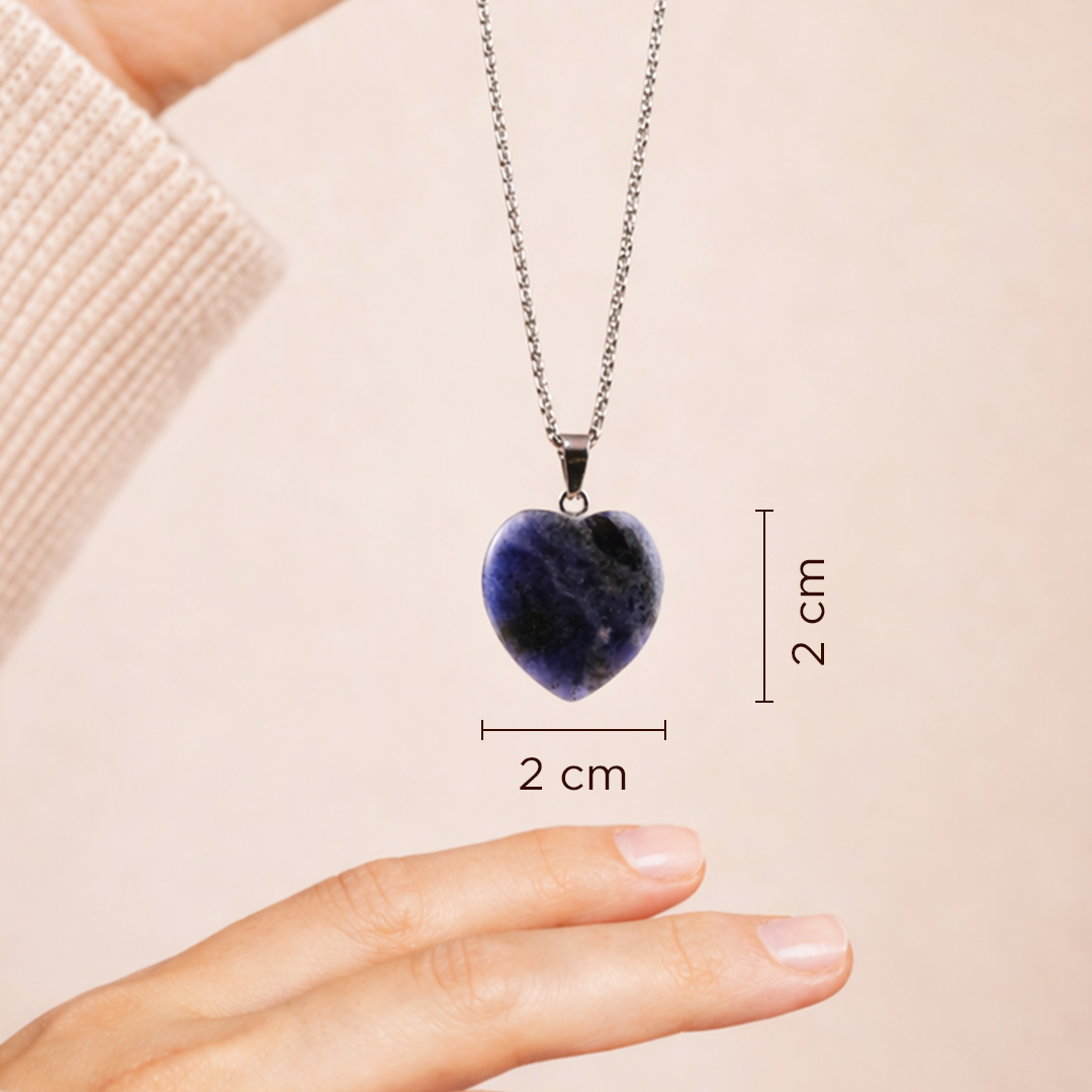 Heart-shaped pendant necklace with measurements on a hand and beige backgroundSodalite Heart Pendant (Abhimantrit) for Clarity & Communication