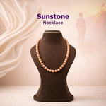 Sunstone necklace on a brown mannequin with a soft, blurred background