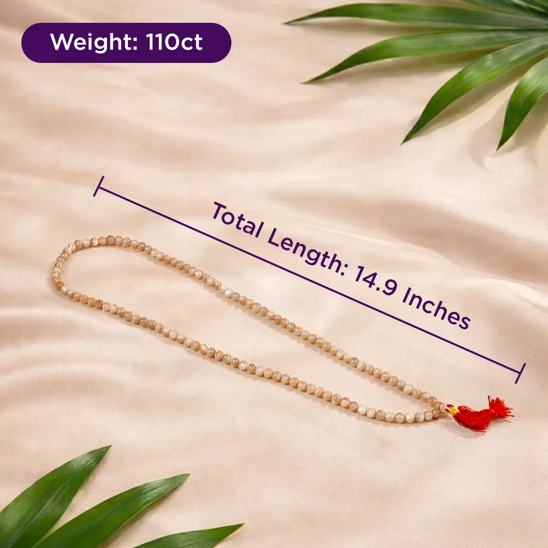 Beaded necklace with tassel on a beige fabric background with green leaves, showing weight and length measurements.Sunstone Necklace for Confidence, Positivity & Success