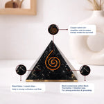 Pyramid-shaped crystal with copper spiral coil on a white background