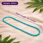 Turquoise beaded necklace with measurements on a beige fabric background