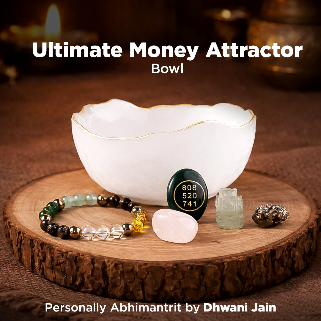 White bowl with crystals and a bracelet on a wooden surface, labeled 'Ultimate Money Attractor Bowl'.