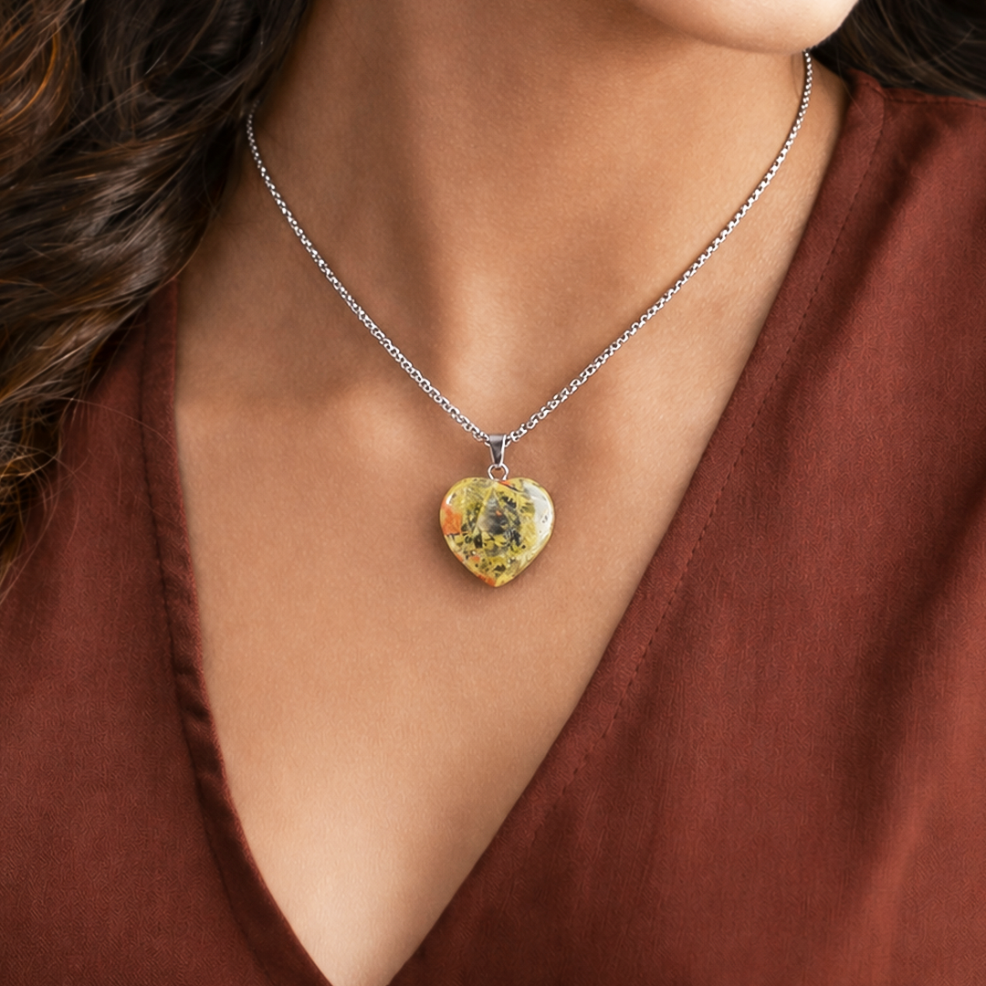 Heart-shaped pendant necklace on a person wearing a brown topUnakite Heart Pendant (Abhimantrit) for Emotional Healing & Balance
