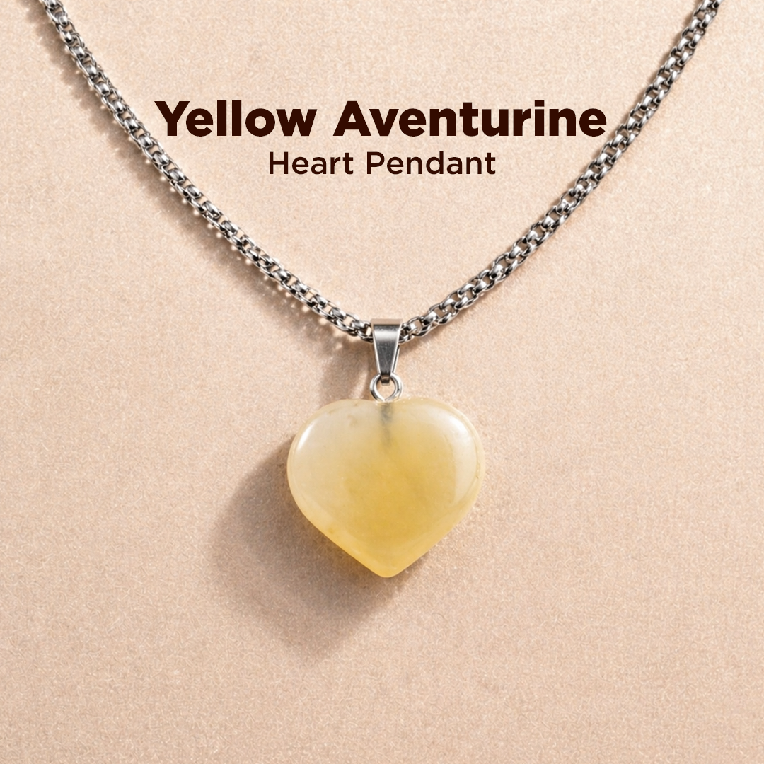 Yellow aventurine heart pendant necklace on a beige background